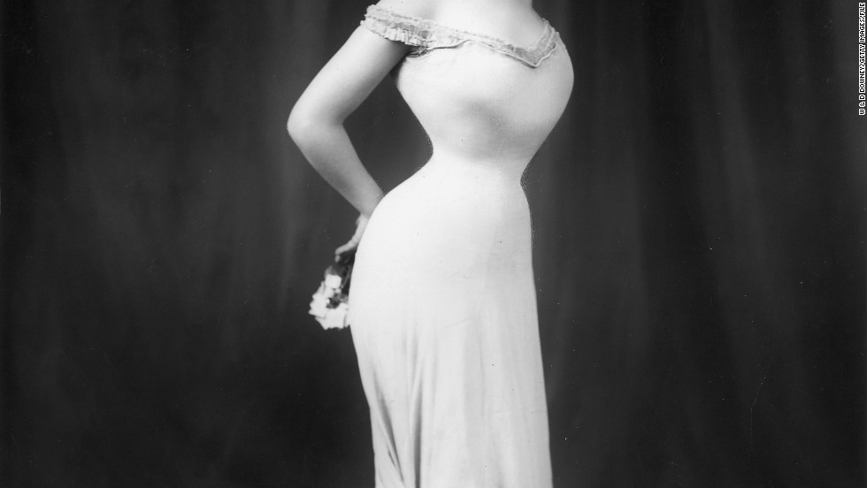 A new exhibition at London&#39;s Design Museum looks back at how women have used clothes to empower themselves. Danish-born actress Camille Clifford&#39;s trademark style was a long, elegant gown wrapped around her tightly corseted, 18-inch waist, pictured here in 1905.