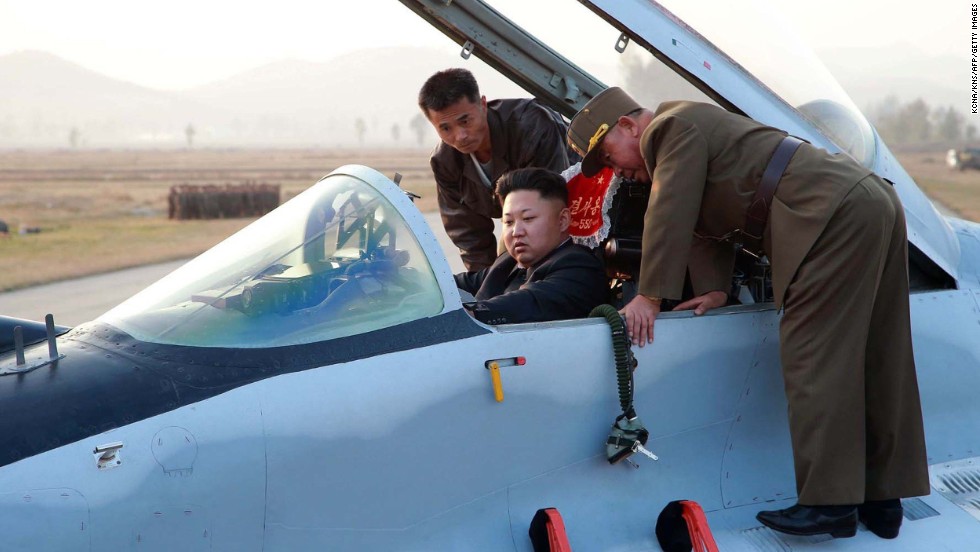 Kim sits in the pilot&#39;s seat of a fighter jet during the inspection.
