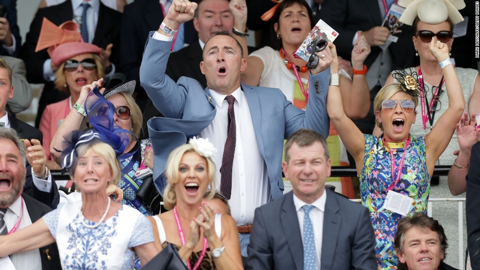 Protectionist&#39;s part owner Jamie Lovett whoops in the stands as the five-year-old bay stallion passes the post four lengths in front of his rivals.