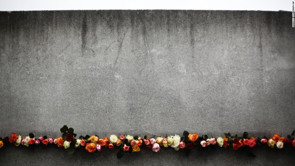 Flowers are placed in a crack of the former Berlin Wall to commemorate the victims killed at the wall.