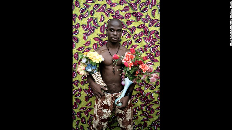 In each picture, the strength of the musclemen is contrasted with the delicacy of the flowers they hold.