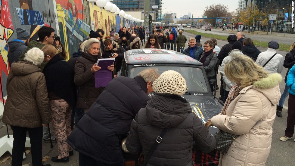 &quot;On November 9, thousands of people crowded around our car to sign it, draw on it, and take their picture with it. At some point the authorities asked us to stop because the crowd grew so large that it was blocking the bike path and the street at the East Side Gallery,&quot; says Pleitgen.