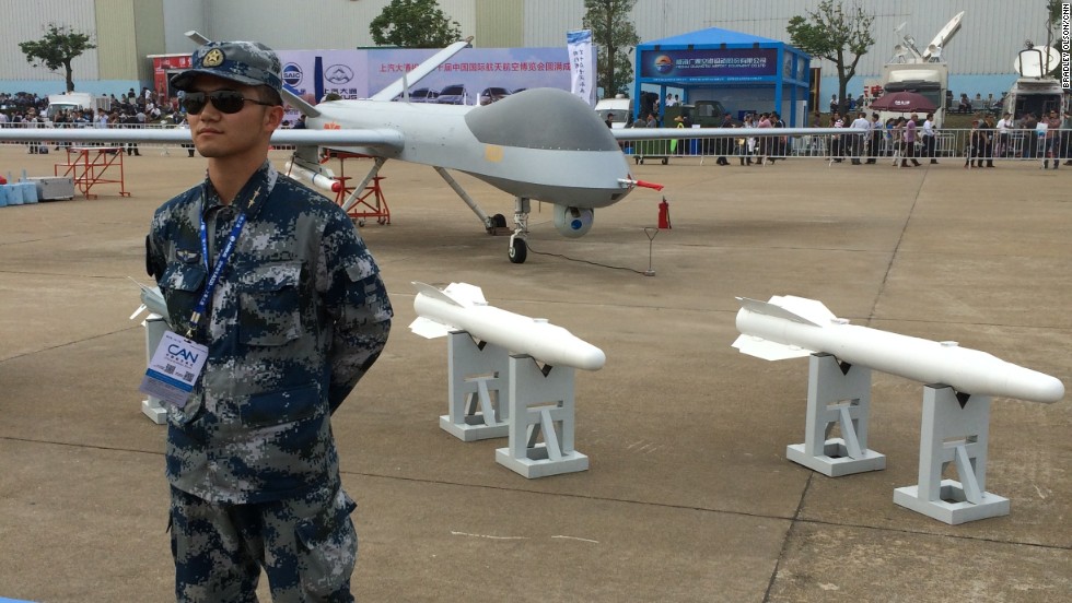 A guard stands by a Chinese-made drone at Airshow China on Tuesday, November 11. 