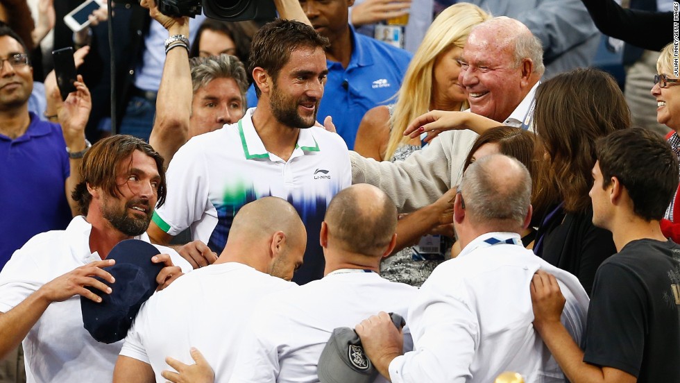 Cilic and a visibly-drained Ivanisevic celebrate with their support team following the world No. 9&#39;s first grand slam victory. 