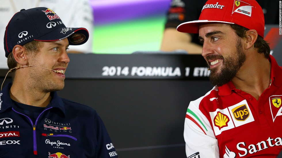 Swapping sides: Fernando Alonso (right) is leaving Ferrari but he will be replaced in 2015 by Red Bull&#39;s four-time world champion Sebastian Vettel (left).