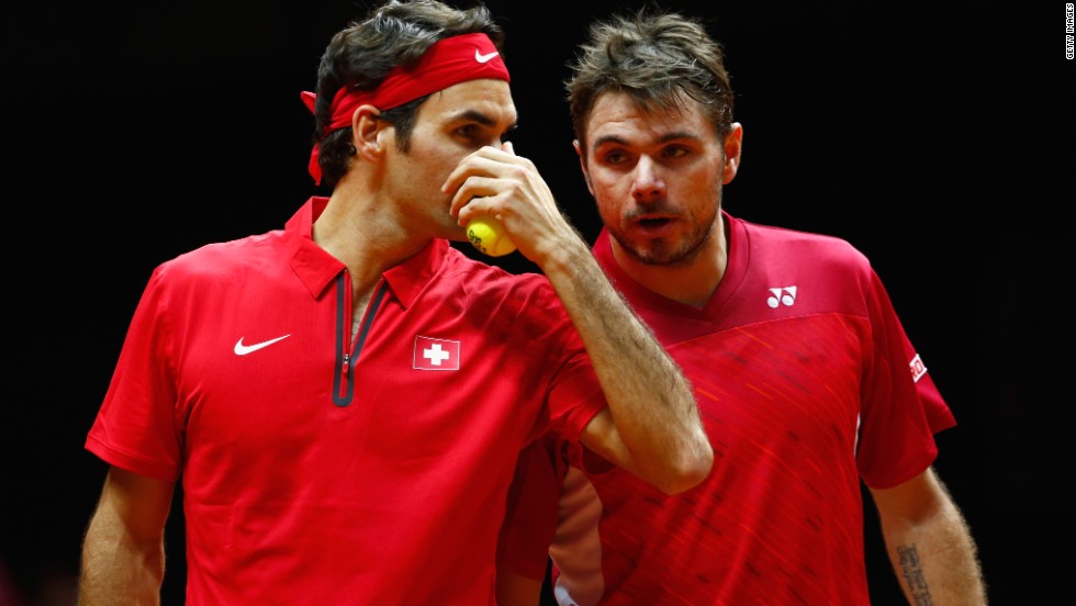 The Swiss pair talk tactics during their doubles match against France&#39;s Gasquet and Julien Benneteau.