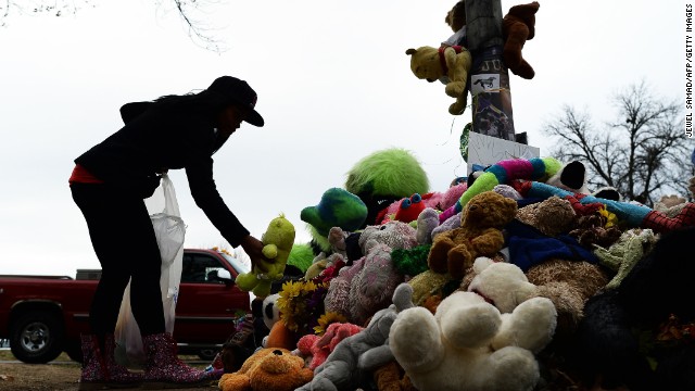 In late November, a wellwisher aranges stuffed toys at a makeshift memorial where 18-year-old Michael Brown was shot dead by a Ferguson police office.