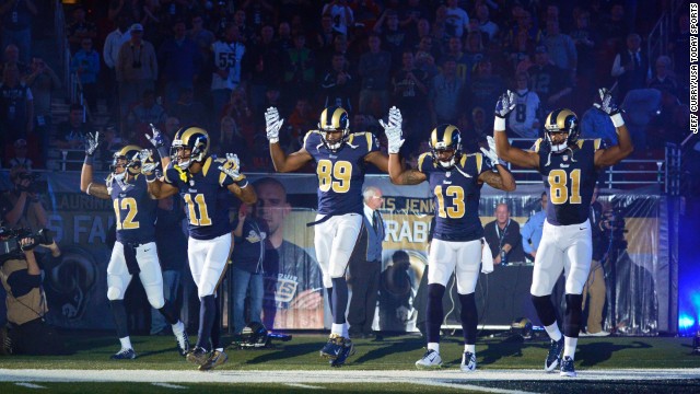 St. Louis Rams wide receiver Stedman Bailey (12) and wide receiver Tavon Austin (11) and tight end Jared Cook (89) and wide receiver Chris Givens (13) and wide receiver Kenny Britt (81) put their hands up to show support for Michael Brown before a game against the Oakland Raiders at the Edward Jones Dome. 