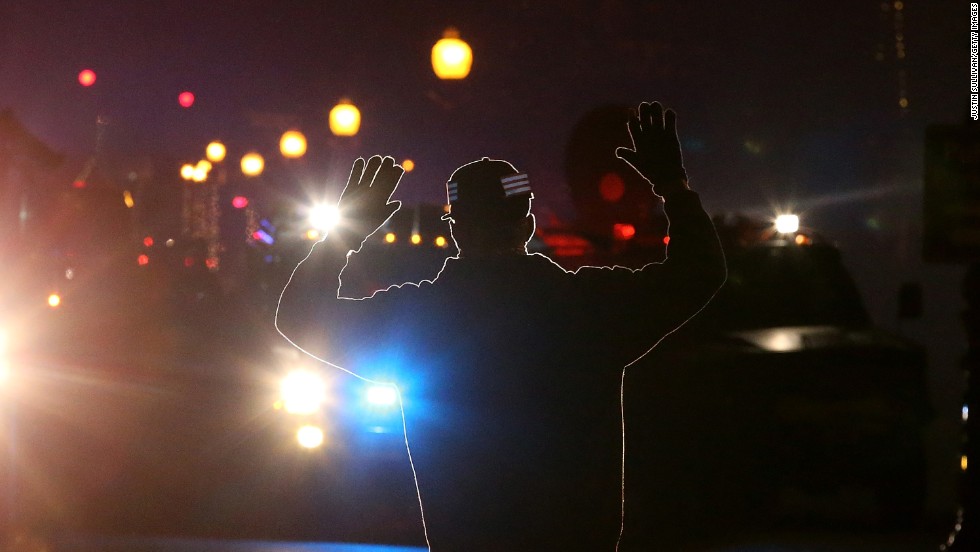 A protester in Ferguson, Missouri, stands in front of police vehicles with his hands up on November 24, 2014. A grand jury&#39;s decision not to indict police Officer Darren Wilson in the killing of Michael Brown prompted&lt;a href=&quot;http://www.cnn.com/2014/11/24/justice/gallery/ferguson-reaction/index.html&quot;&gt; waves of protests in Ferguson&lt;/a&gt; and across the country. The &quot;hands up, don&#39;t shoot&quot; gesture became a rallying cry and protest symbol.