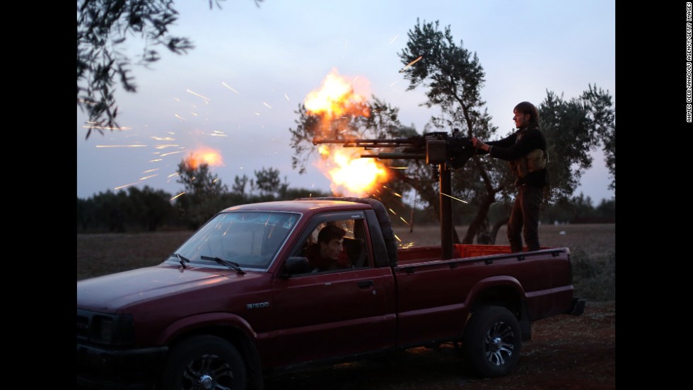 A Syrian opposition fighter fires at Bashar al-Assad Regime forces in the Handarat district of Aleppo on Thursday, November 20.