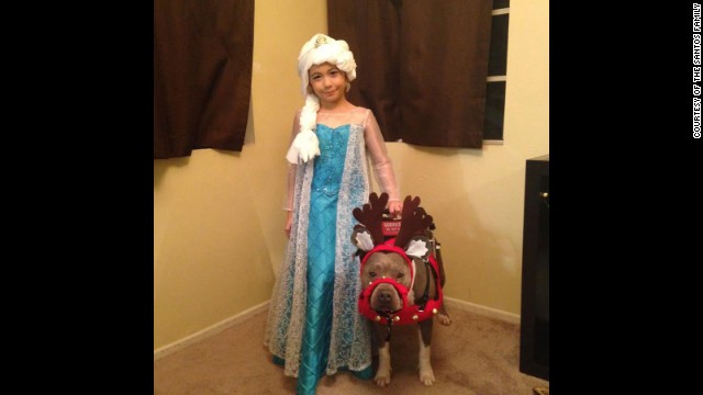  Abcde Santos, 7, has autism and is assisted by her service dog, Pup-Cake. 