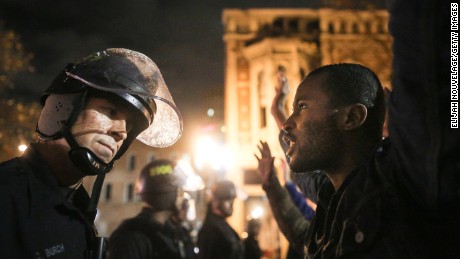 OAKLAND, CA - DECEMBER 3:  Protesters face off following a Staten Island, New York grand jury&#39;s decision not to indict a police officer in the chokehold death of Eric Garner on December 3, 2014 in Oakland, California. The grand jury declined to indict New York City Police Officer Daniel Pantaleo in Garner&#39;s death.  (Photo by Elijah Nouvelage/Getty Images)