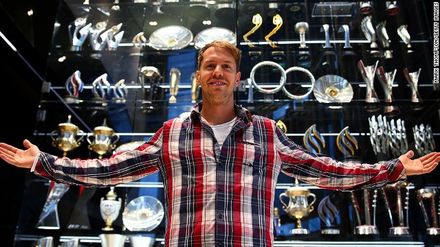Four time world champion Sebastian Vettel stands in front of Red Bull&#39;s trophy cabinet which has been cleared out by burglars