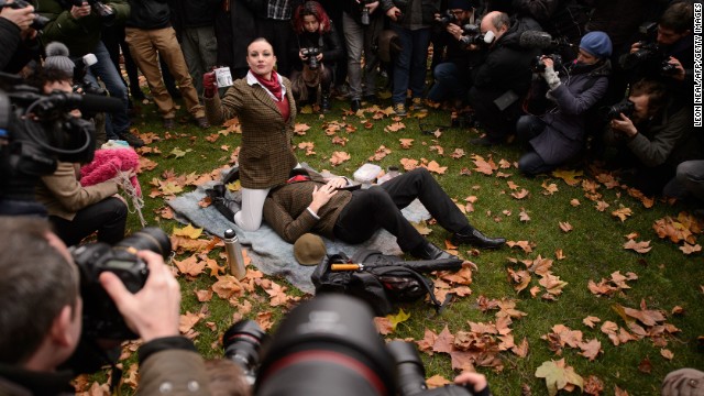 Demonstrators take part in a mass &quot;face-sitting protest&quot; outside the Houses of Parliament in central London.
