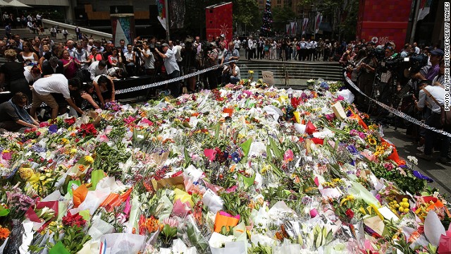 SYDNEY, AUSTRALIA - DECEMBER 16: Flowers are left as a sign of respect at Martin Place on December 16, 2014 in Sydney, Australia. The siege in Sydney&#39;s Lindt Cafe in Martin Place is over after 16 hours. Police raided the cafe just after 2am AEDT on Tuesday morning. Three people have been confirmed killed, two hostages and the gunman. (Photo by Mark Metcalfe/Getty Images)