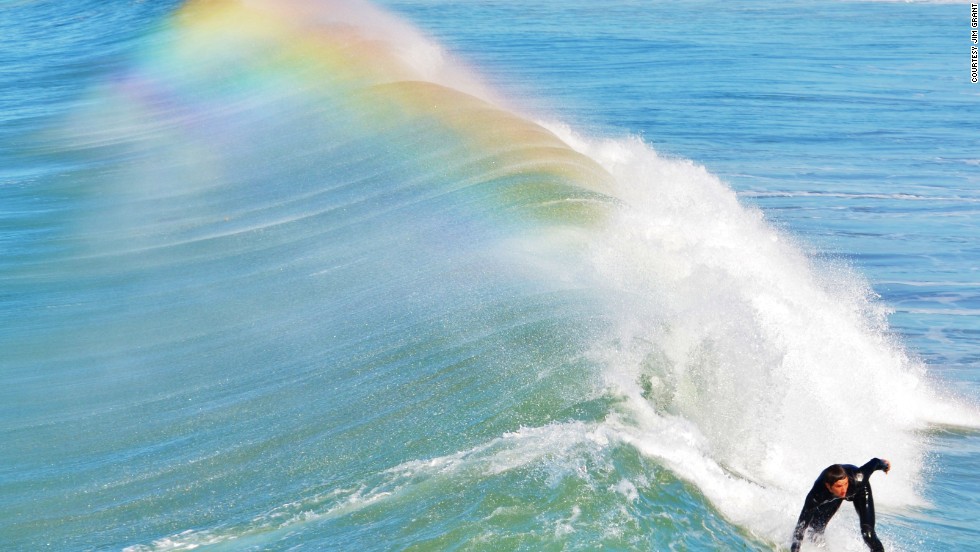 A surfer rides a wave off the coast of &lt;a href=&quot;http://ireport.cnn.com/docs/DOC-1078219&quot;&gt;San Diego, California&lt;/a&gt;. 