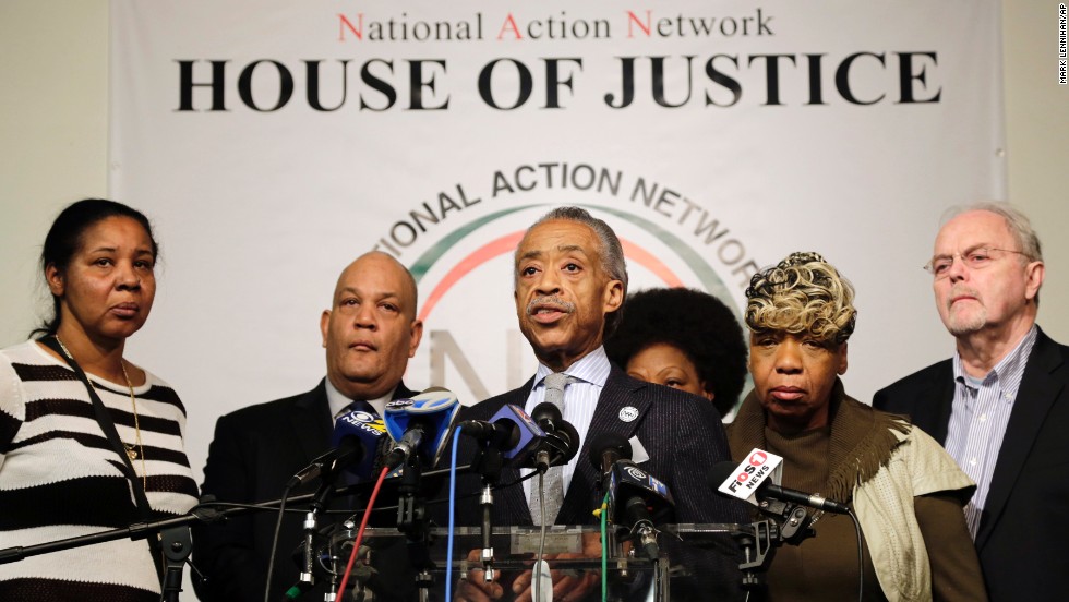 The Rev. Al Sharpton, center, speaks about the killings of the officers during a news conference at the National Action Network headquarters in New York on December 21. Behind him are, from left, Esaw Garner, widow of Eric Garner; attorney Michael Hardy; Gwen Carr, mother of Eric Garner; and attorney Jonathan Moore.