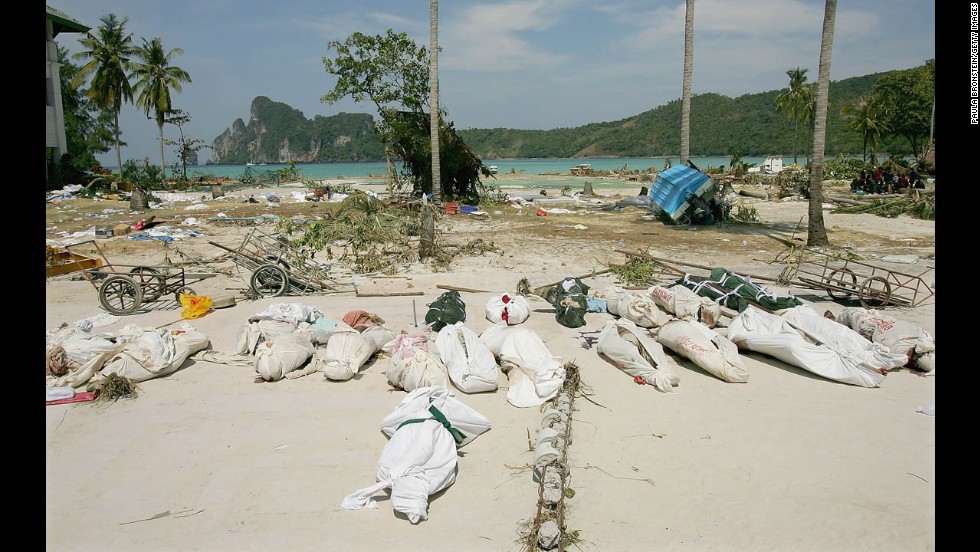 Bodies lay covered in the street waiting to be transported by boat from Phi Phi Village to Phuket and Krabi on December 28, 2004. 