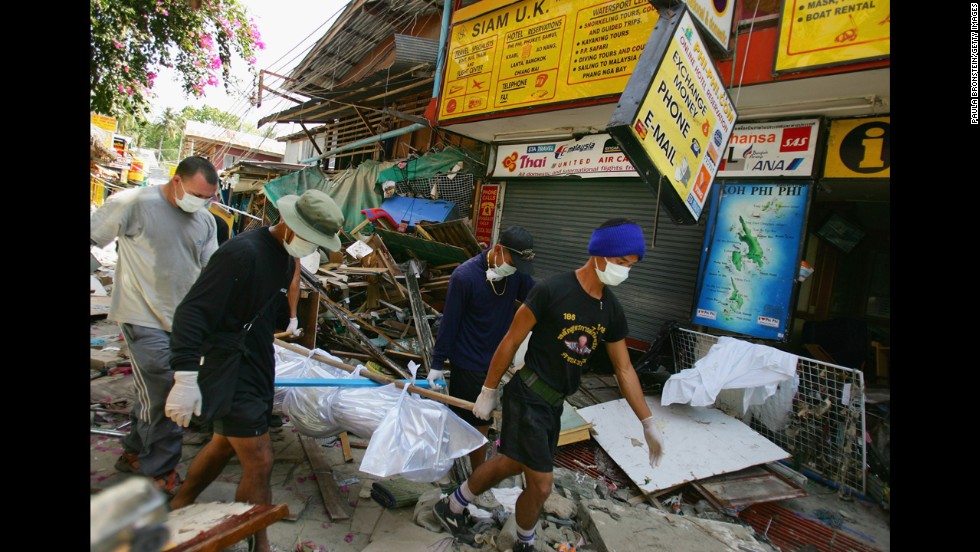 Rescue workers carry a body from among the debris on December 28, 2004.