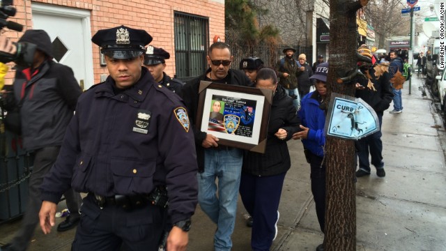 Visitors pay respects to two slain police officers this week at a memorial in New York&#39;s Bedford-Stuyvesant neighborhood.