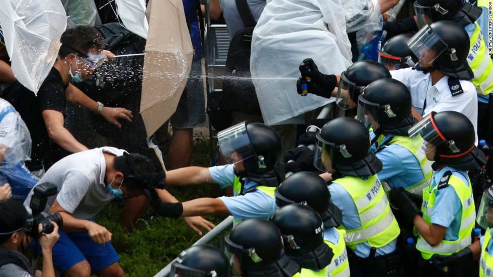 Riot police use pepper spray as they clash with pro-democracy protesters outside the government headquarters in Hong Kong on September 28, 2014. &lt;a href=&quot;http://www.cnn.com/2014/09/22/asia/gallery/hong-kong-students-protest/index.html&quot;&gt;Demonstrations began&lt;/a&gt; in response to China&#39;s decision to allow only Beijing-vetted candidates to stand in the city&#39;s 2017 election for chief executive. Protesters say Beijing has gone back on its pledge to allow universal suffrage in Hong Kong, which was promised &quot;a high degree of autonomy&quot; when it was handed back to China by Britain in 1997. The umbrella has become the defining image of the protest movement, used to shield protesters from tear gas and the elements.