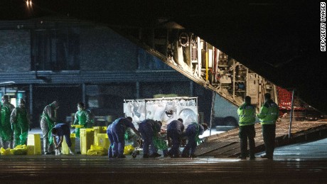 Pauline Cafferkey is wheeled in a quarantine tent trolley onto a Hercules Transport plane at Glasgow Airport on December 30, 2014.