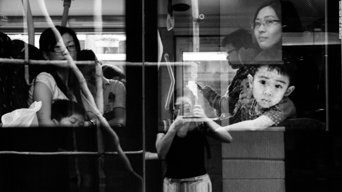 Bacani catches her reflection on a bus in Causeway Bay, one of Hong Kong&#39;s busiest shopping districts. She has lived in the city for nine years and still doesn&#39;t feel like she belongs. &quot;When you&#39;re a helper, you don&#39;t have a right to be a photographer,&quot; she says.