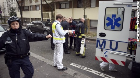 Firefighters carry an injured man on a stretcher in front of the offices of the French satirical newspaper Charlie Hebdo in Paris on January 7, 2015, after armed gunmen stormed the offices leaving at least 10 people dead. AFP PHOTO / MARTIN BUREAU        (Photo credit should read MARTIN BUREAU/AFP/Getty Images)