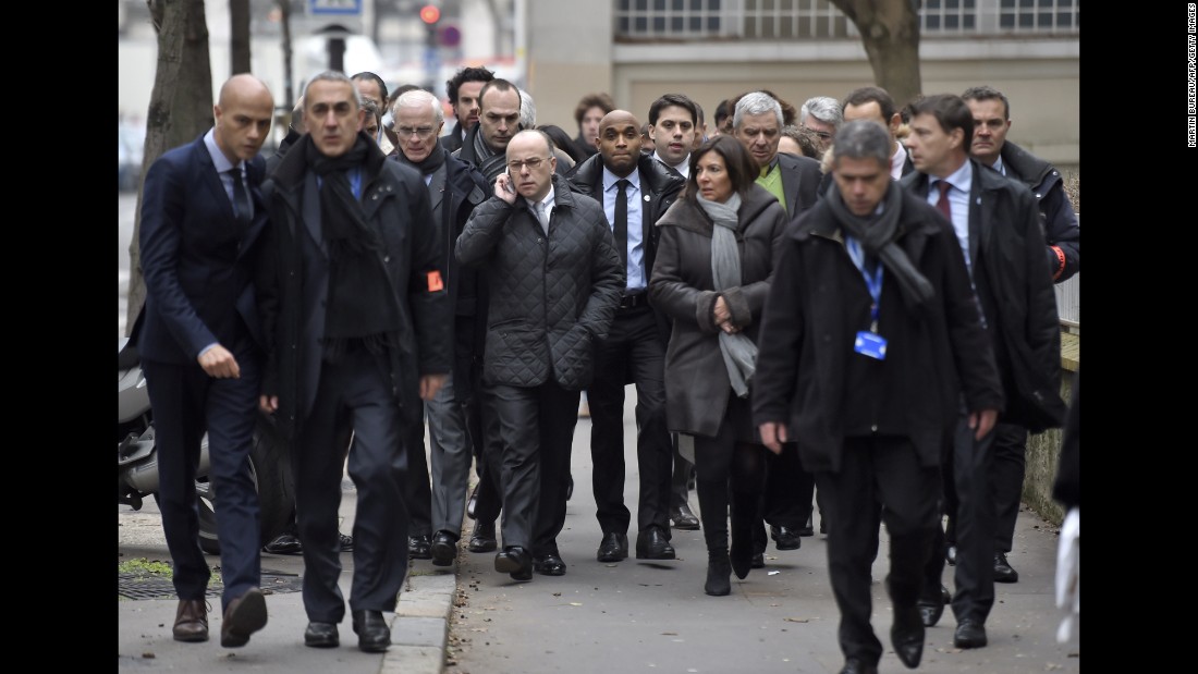 Paris Mayor Anne Hidalgo and Interior Minister Bernard Cazeneuve arrive at the scene.