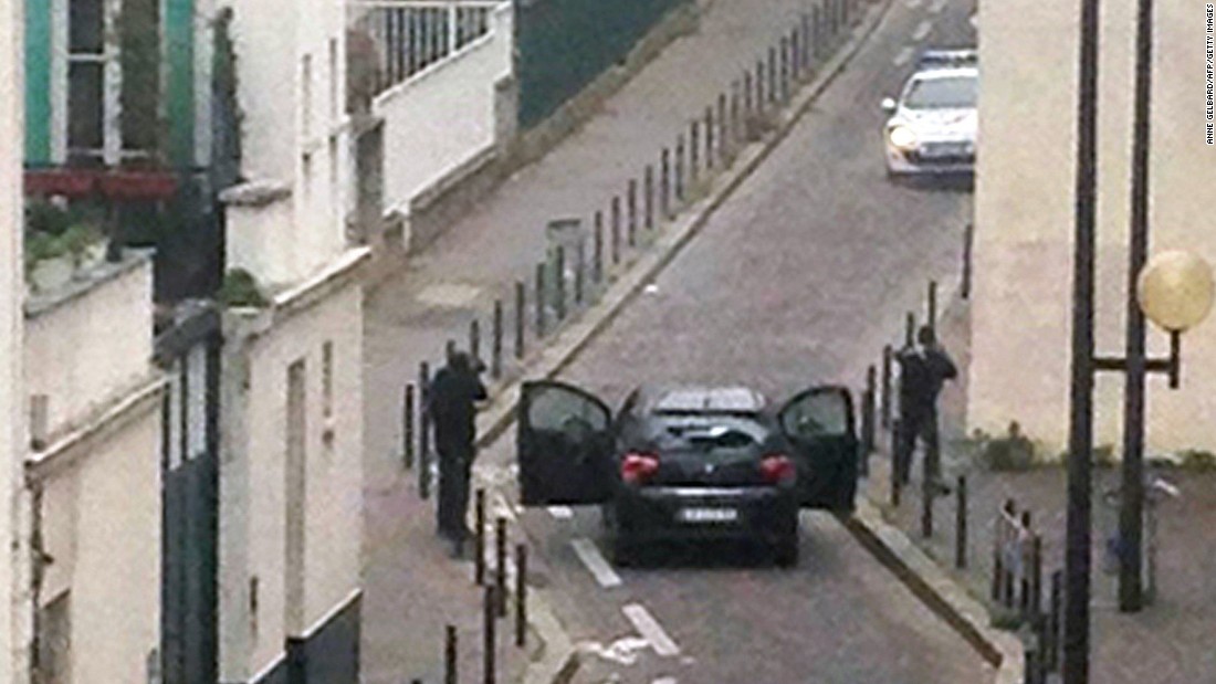 Gunmen face off with police officers in Paris on Wednesday, January 7. A terrorist attack at the Paris office of Charlie Hebdo, a French satirical magazine, left at least 12 people dead.