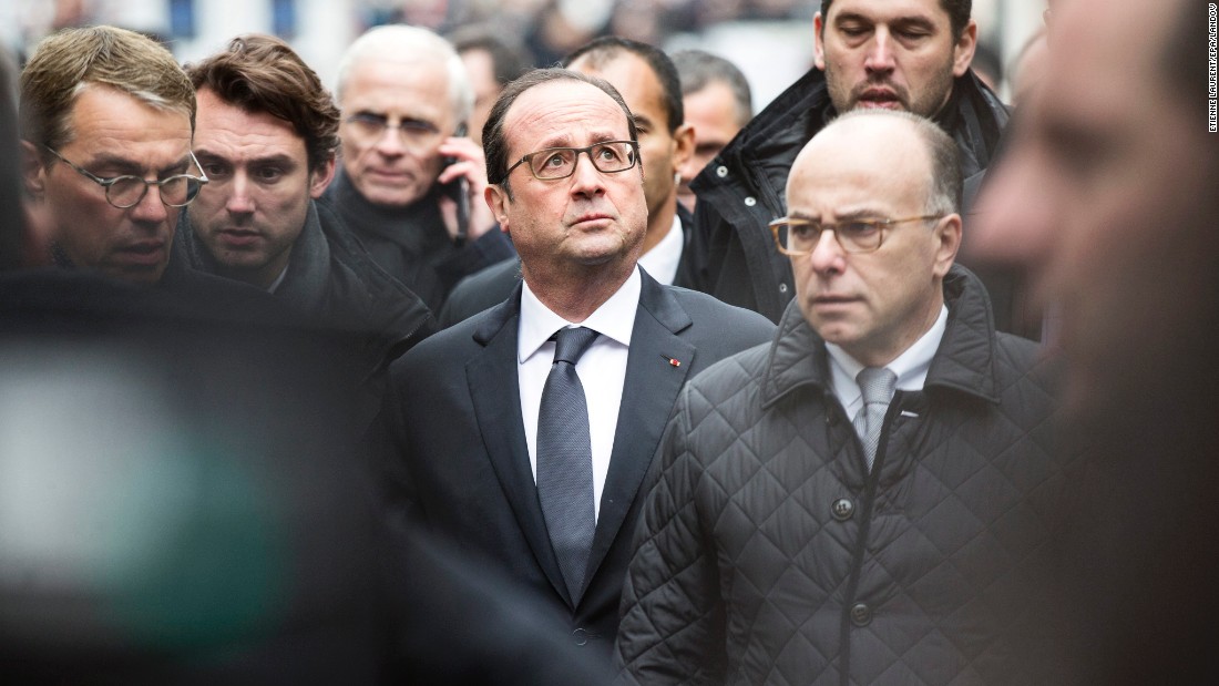 French President Francois Hollande, center, and Cazeneuve, right, arrive at the scene of the shooting.