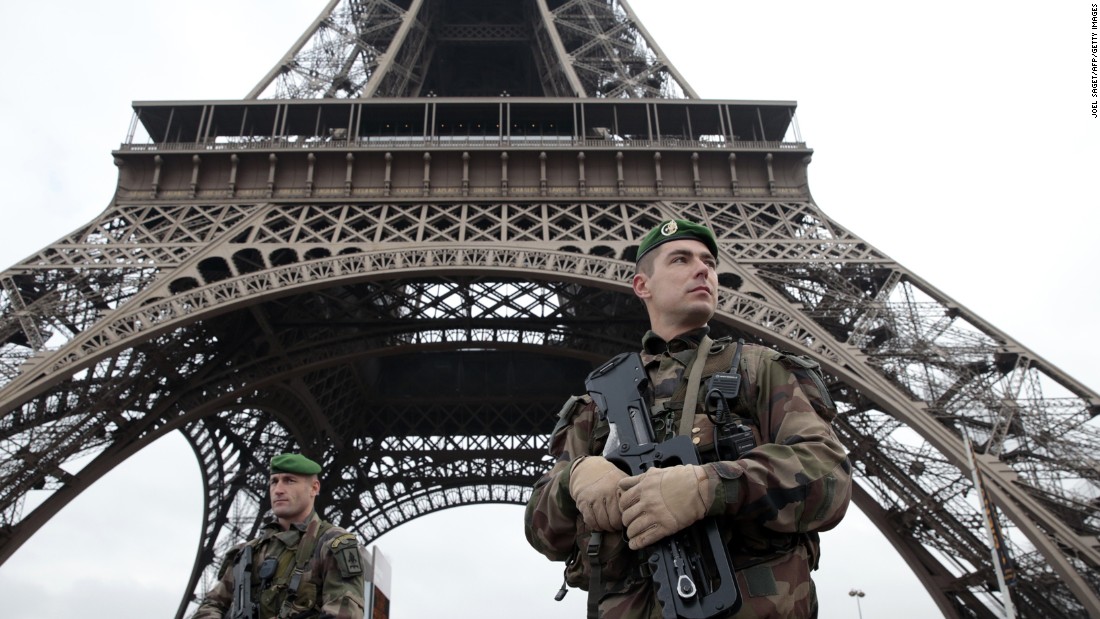 French soldiers patrol around the Eiffel Tower.