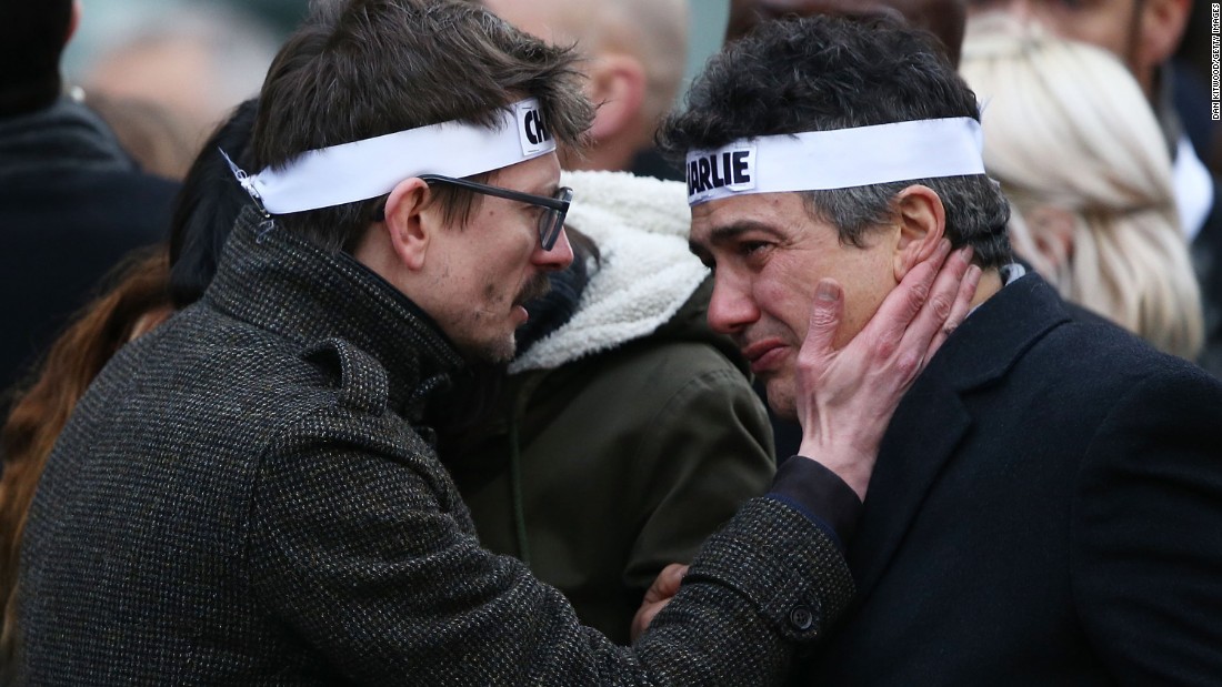 Charlie Hebdo cartoonist Renald &quot;Luz&quot; Luzier, left, speaks to Charlie Hebdo journalist Patrick Pelloux during the rally. Luzier is the only surviving cartoonist left at the magazine.