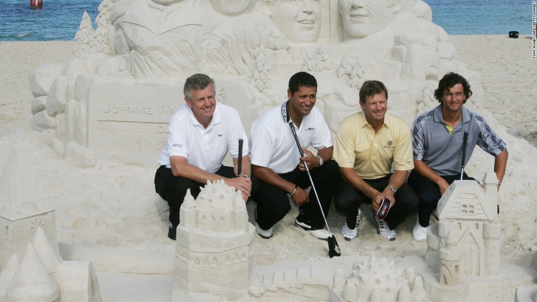 Colin Montgomerie, Michael Campbell, Retief Goosen and Adam Scott line up in front of sand sculptures of themselves at Cottesloe Beach, Australia, before the 2006 Johnnie Walker Classic.