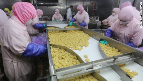 Workers producing food at a factory in Shanghai. 