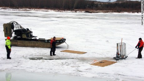 Cleanup workers cut holes into the ice on the Yellowstone River near Crane, Mont. on Monday, Jan. 19, 2015 as part of efforts to recover oil from an upstream pipeline spill that released up to 50,000 gallons of crude. (AP Photo/Matthew Brown)
