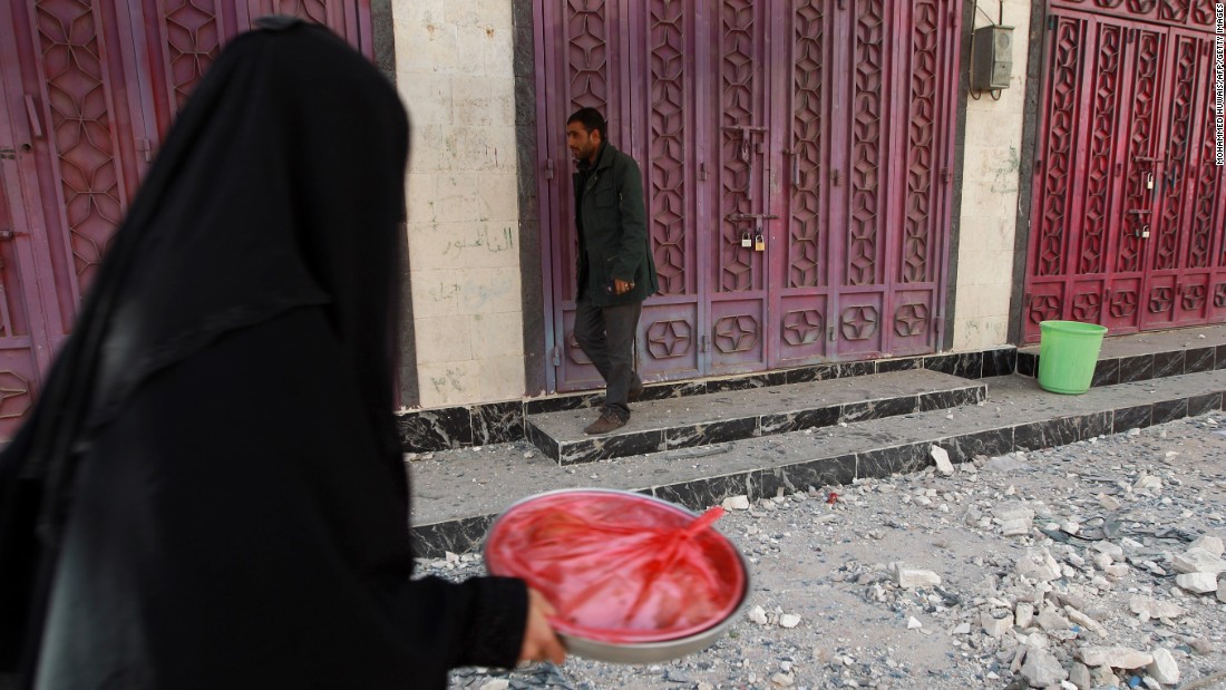 A woman walks past closed shops in Sanaa on January 20.