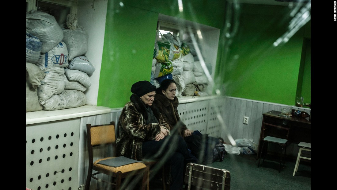 Women sit in a shelter during a battle in Donetsk on Sunday, January 18.