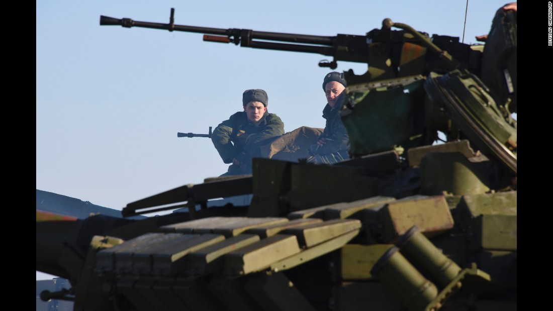 Rebels sit atop a tank at a checkpoint north of Luhansk, Ukraine, on Wednesday, January 14.