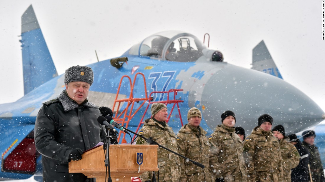 Ukrainian President Petro Poroshenko gives a speech as he hands over new military equipment to forces near the city of Ghytomyr, Ukraine, on Monday, January 5.