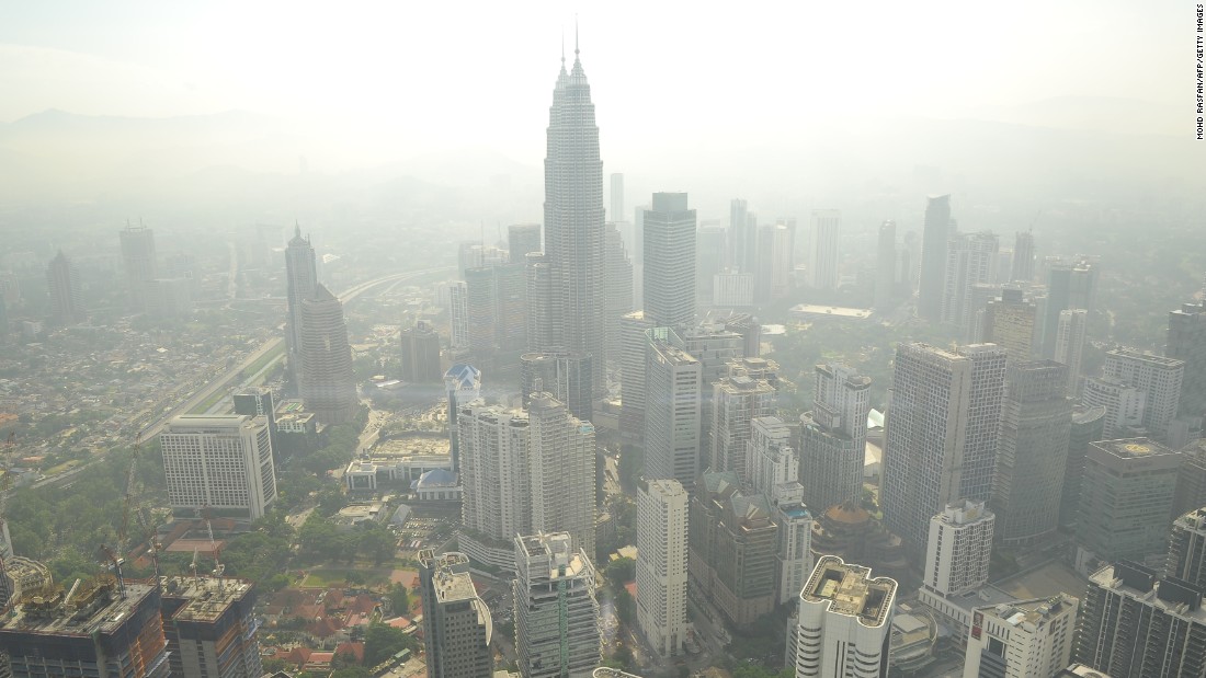 A haze has periodically wafted over Southeast Asia for 20 years. It is especially bad in the Asia-Pacific region, which has a population of over 4.2 billion and high population density. Pictured, smog hovers above the Kuala Lumpur skyline in June 2013. 