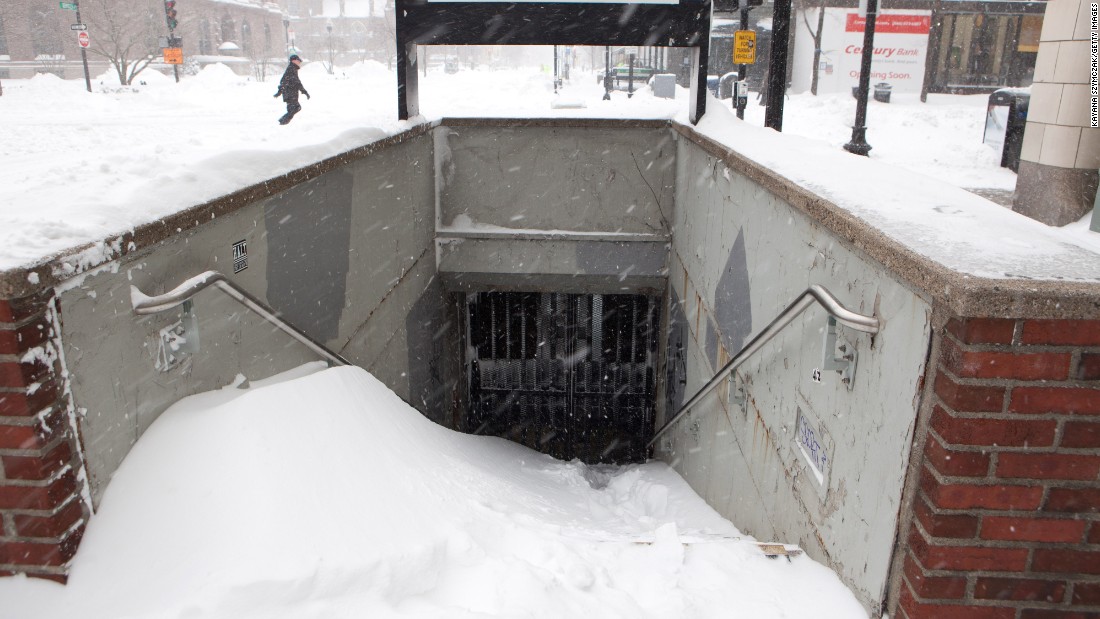 Snow piles up at the entrance of a closed T station in Boston on January 27. The city&#39;s public transit system was set to reopen the next day.
