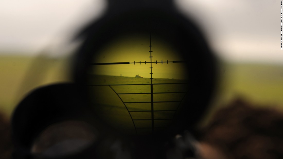 ISIS militants are seen through a rifle&#39;s scope during clashes with Peshmerga fighters in Mosul, Iraq, on Wednesday, January 21.