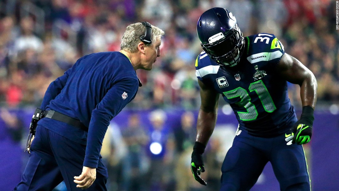 Seattle head coach Pete Carroll talks to Kam Chancellor in the second half.
