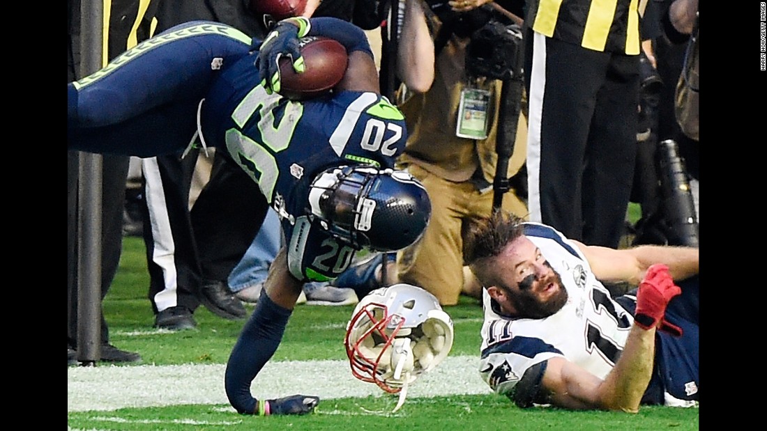 Seattle defensive back Jeremy Lane suffers a broken arm after he intercepted Brady and was tackled by Edelman, right.