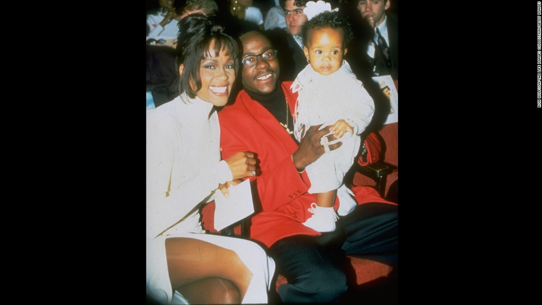 In this undated photo, probably from 1993, Houston and her husband pose with their infant daughter.