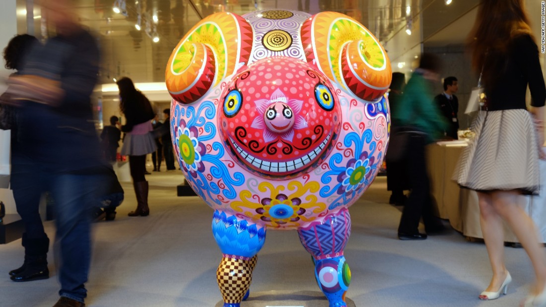 Tourists in Taipei, Taiwan, walk past a statue made by Taiwanese sculptor Hung Yi to celebrate the Year of the Sheep on Friday, January 23. 