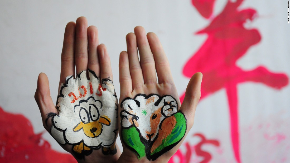 College students in China&#39;s Shandong province paint sheep on their hands on Tuesday, December 30.