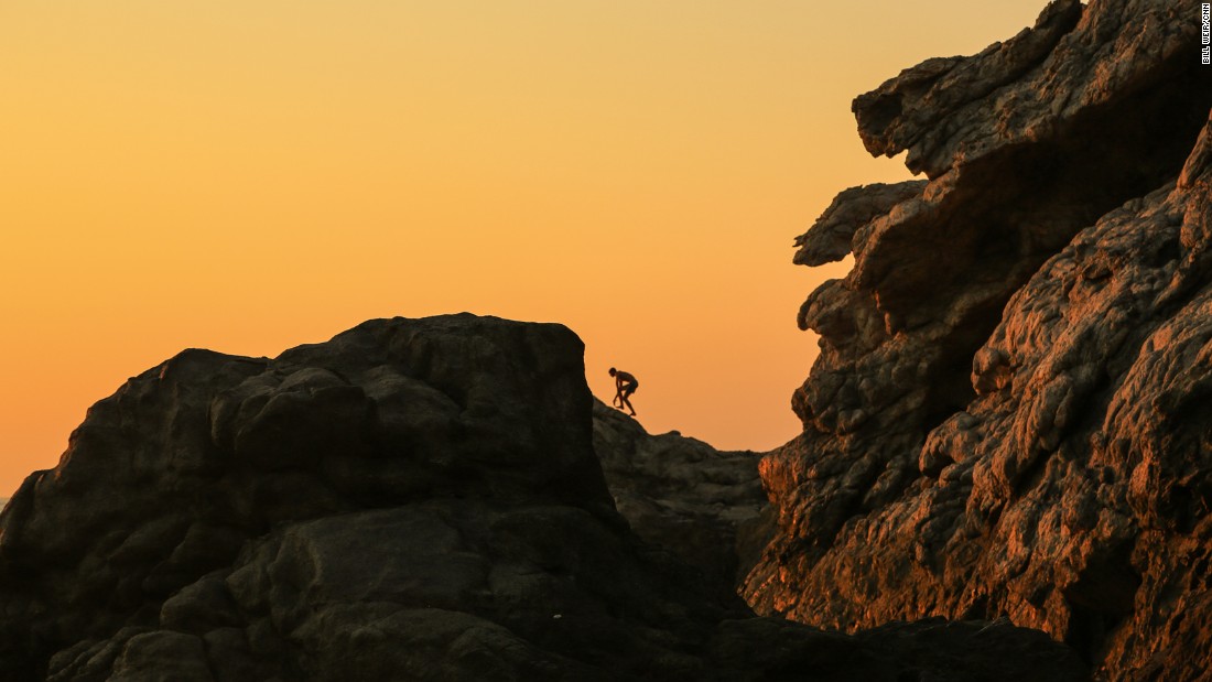 A climber navigates the rocky ridges above Artemis&#39; Cove.
