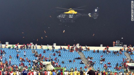 A police helicopter flies over the statdium during an interruption of the 2015 African Cup of Nations semi-final football match between Equatorial Guinea and Ghana in Malabo, on February 5, 2015. Play was halted eight minutes from time in the Africa Cup of Nations semi-final between hosts Equatorial Guinea and Ghana when missiles were thrown on the pitch. AFP PHOTO / ISSOUF SANOGOISSOUF SANOGO/AFP/Getty Images